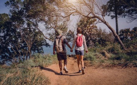 Photo for Happy young couple traveling in the jungle forest near the ocean. - Royalty Free Image