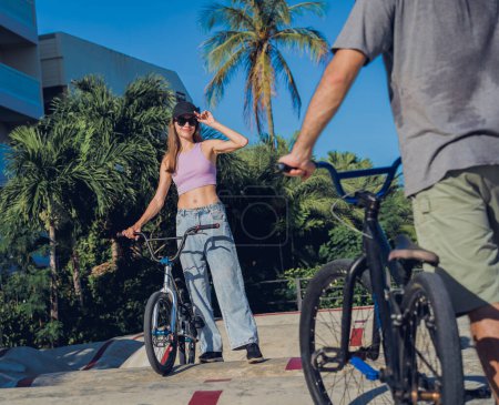 Photo for Young happy couple enjoy BMX riding at the skatepark. - Royalty Free Image