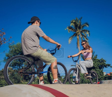Photo for Young happy couple enjoy BMX riding at the skatepark. - Royalty Free Image