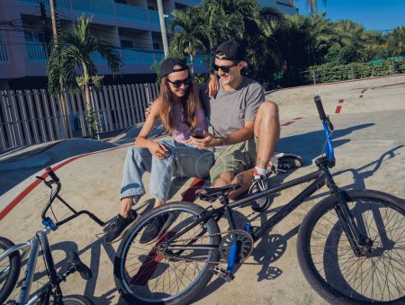 Photo for Young happy couple with BMX taking selfie at the skatepark. - Royalty Free Image
