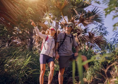 Photo for Happy young couple traveling in the jungle forest near the ocean. - Royalty Free Image