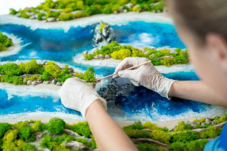Photo for The process of making the art decor of epoxy resin, natural stones and moss. - Royalty Free Image