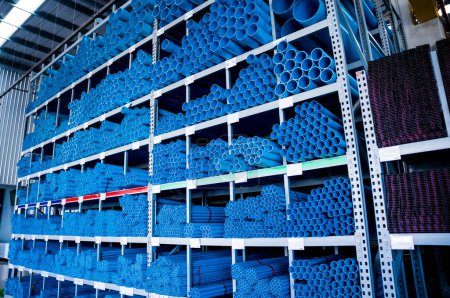 Photo for Blue plastic pipes in a stack in a large warehouse of a shopping center. - Royalty Free Image