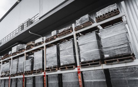 Photo for Pallets full of blocks goods stored outside warehouse. - Royalty Free Image