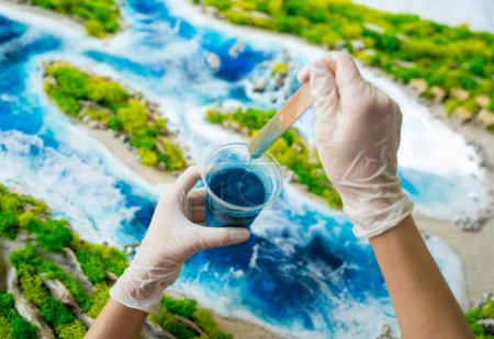 Photo for The process of making the art decor of epoxy resin, natural stones and moss. - Royalty Free Image