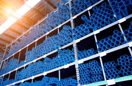 Photo for Blue plastic pipes in a stack in a large warehouse of a shopping center. - Royalty Free Image