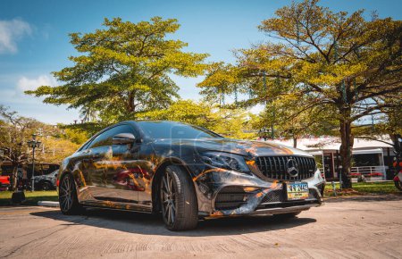 Photo for PHUKET, THAILAND- DECEMBER 24, 2023: Beautiful bright Mercedes AMG E53 against of nature with palms. - Royalty Free Image