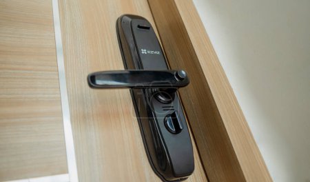 Photo for Modern smart door lock on the wooden door in a cozy apartment. - Royalty Free Image