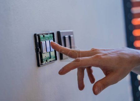Photo for Technician installing sensor light switch at modern villa. - Royalty Free Image