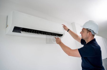 Photo for Technician cleans air conditioner system in a modern apartment - Royalty Free Image