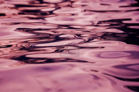 A image of violet ocean waves featuring a water surface in detail.