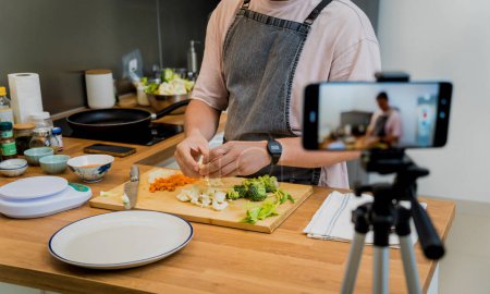 Foto de El chef está transmitiendo en vivo desde el taller cómo preparar una sopa de lentejas vegetarianas. - Imagen libre de derechos