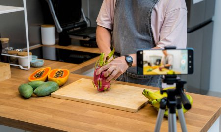 Foto de El chef está transmitiendo en vivo desde el taller cómo cortar y pelar la fruta del dragón. - Imagen libre de derechos