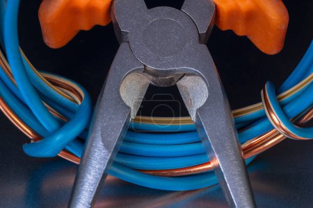 Photo for Close-up cutting pliers tool and electrical cable - Royalty Free Image