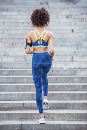 Photo for Back view of beautiful girl in sportswear running - Royalty Free Image