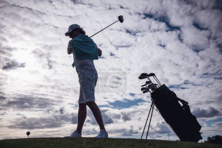 Photo for Full length portrait of handsome man using a golf club while playing golf - Royalty Free Image