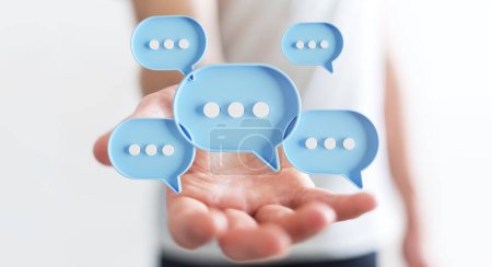 Photo for Businessman using digital blue speech bubbles talk icons. Minimal conversation or social media messages floating over user hand. 3D rendering - Royalty Free Image