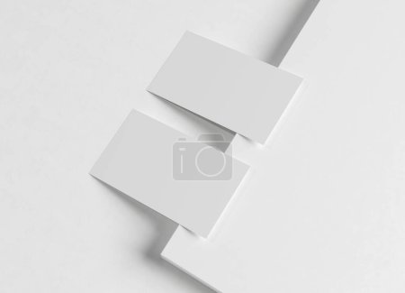 Foto de Dos tarjetas de visita blancas burlándose. Plantilla de tarjeta de visita texturizada en una superficie cuadrada en blanco. Renderizado 3D - Imagen libre de derechos