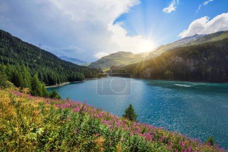 Photo for Beautiful view of the emerald alpine lake. Dramatic and picturesque scene. Mountain lake in the background of mountains and sky - Royalty Free Image