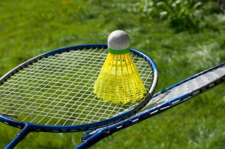 Photo for Badminton rackets with a ruffle on the background of green grass - Royalty Free Image