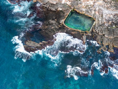 Photo for Tidal swimming pool built into the rocky cliffs of the coastline.  Aerial views - Royalty Free Image