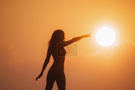 Photo for Strong woman winning, motivation, and bright future concept. Confident woman pointing a finger to the sun. - Royalty Free Image