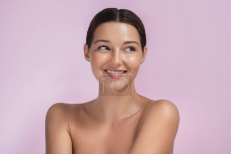 Beauty young Asian woman portrait isolated on pink background with surprised emotion. A high-quality photo of a happy excited half naked attractive girl with a perfect smile. 