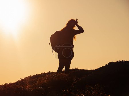 Photo for Hike of tourists hiker woman carrying heavy backpack tired during climbing to the top of the mountain - Royalty Free Image