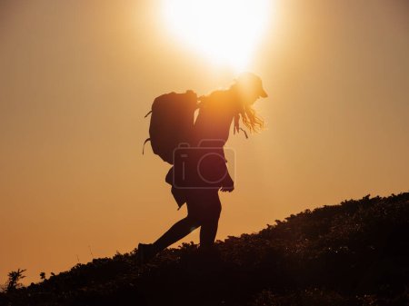 Photo for Hike of tourists hiker woman carrying heavy backpack tired during trekking to the top of the mountain - Royalty Free Image