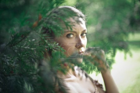 Foto de Mujer fotografiada a través de las hojas de un árbol - Imagen libre de derechos