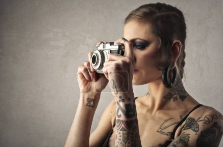 Photo for Young woman takes a picture with a vintage camera - Royalty Free Image