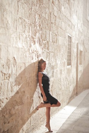 Photo for Beautiful model leaning against a wall in mdina, malta - Royalty Free Image