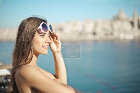 Photo for Young woman on a bridge looks at the view - Royalty Free Image