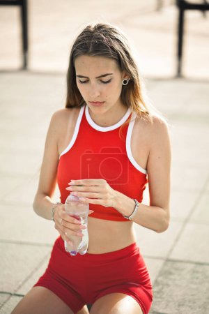 Photo for Portrait of young woman with a plastic bottle in her hand - Royalty Free Image