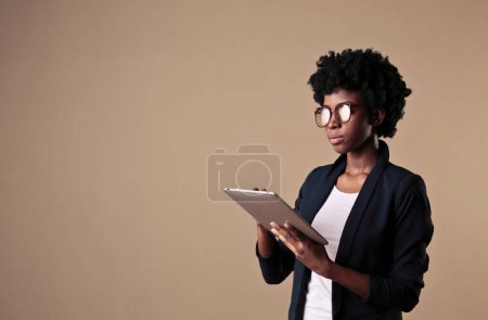 Photo for Portrait of young woman while using a tablet - Royalty Free Image