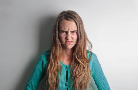 Photo for Portrait of young woman with disgusted expression - Royalty Free Image