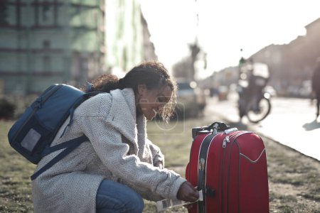 Foto de Mujer joven en la calle con dos maletas - Imagen libre de derechos