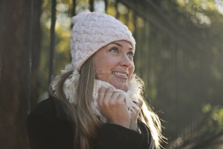 Photo for Cheerful young woman with hat on the street - Royalty Free Image