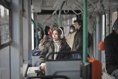Photo for Young woman listens to music on the train - Royalty Free Image