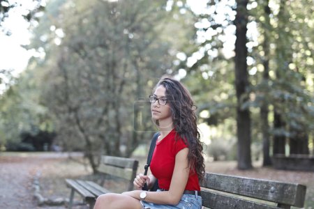 Photo for Portrait  of a young beautiful woman in a park - Royalty Free Image