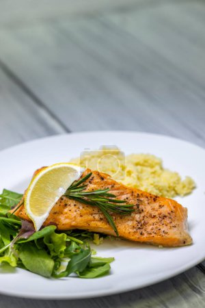 Photo for Grilled salmon served with couscous and vegetables salad - Royalty Free Image