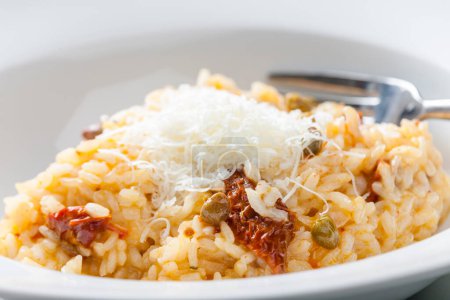 Photo for Italian risotto with dry tomatoes and capers - Royalty Free Image