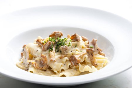 Photo for Cream sauce with chanterelles served with pasta - Royalty Free Image