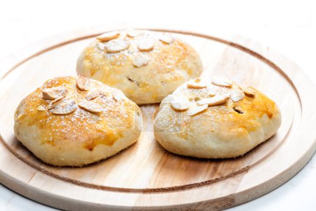 Photo for Almond buns on wooden board - Royalty Free Image