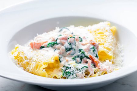 Photo for Pasta with creamy salmon sauce with spinach - Royalty Free Image