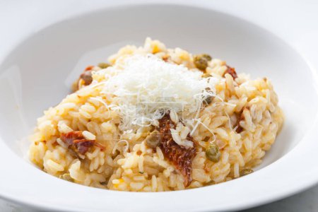 Photo for Italian risotto with dry tomatoes and capers - Royalty Free Image