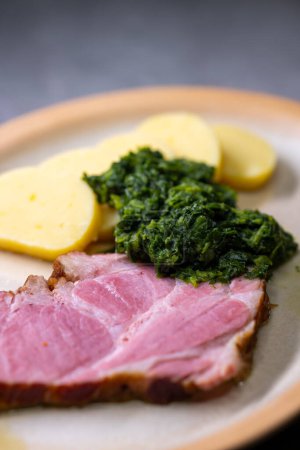 Photo for Smoked meat with spinach and potato dumplings - Royalty Free Image