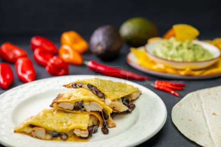 Foto de Quesadilla with chicken meat and beans and guacamole with nachos - Imagen libre de derechos