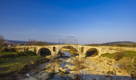 Photo for Pont Julien, roman stone arch bridge over Calavon river, Provence, France - Royalty Free Image