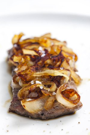 Photo for Steak covered by caramelized onion - Royalty Free Image